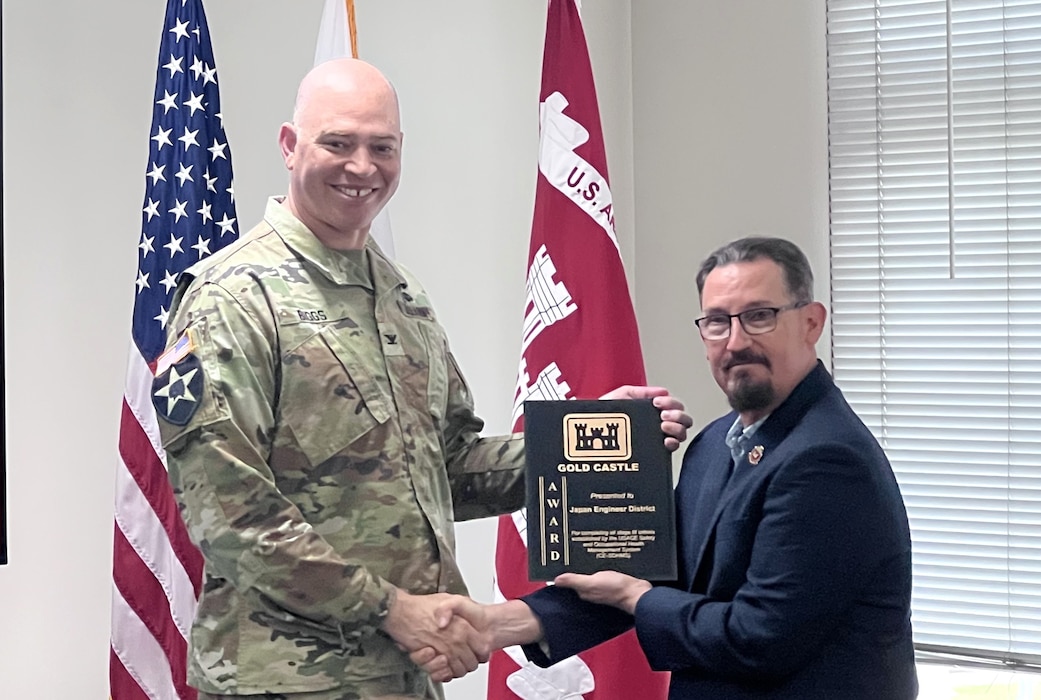 Wade Kerr, Safety Manager, U.S. Army Corps of Engineers – Pacific Ocean Division, presents Col. Patrick Biggs, commander, USACE Japan District, with a plaque to mark the achievement of stage three of the Safety and Occupational Health Management System (CE-SOHMS) on Aug. 21, 2026, at JED headquarters, Camp Zama, Japan. The milestone reflects the integration of safety into the cultures of the district, positioning the district to achieve the Army Safety and Occupational Health Star next. (US Army courtesy photo)