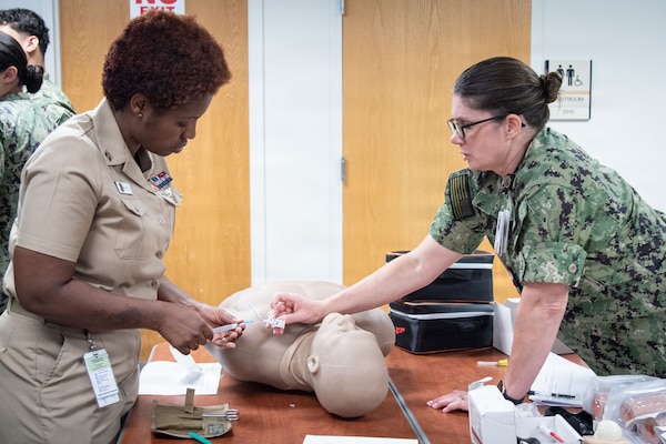 *Training* Navy Cmdr. Christina Tellez, right, Navy Medicine Readiness and Training Command’s Chief Nursing Officer, coaches Navy Lt. Kabresha Smith to properly administer an oropharyngeal airway Thursday, August 20, 2026.

The training was part of a Skills Fair organized by Tellez for nurses and corpsmen assigned to the facility to evaluate their knowledge and train them on competencies and tasks expected of them in an operational environment.