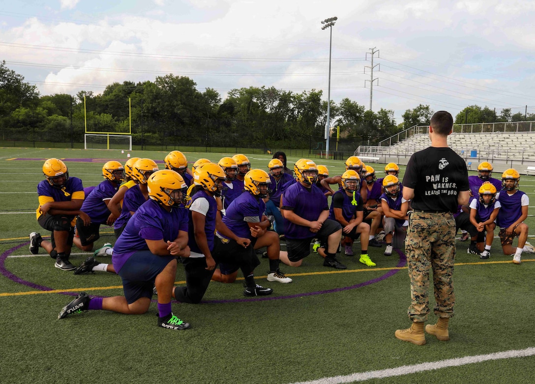 U.S. Marine Corps Staff Sgt. Dylan Garcia, a canvassing recruiter with Recruiting Sub-Station Smithtown, Recruiting Station New York, speaks to the Central Islip High School football team prior to conducting a workout, Central Islip, New York, Aug. 18, 2026. The Marines conducted the workout with the football players to build relations within the local community and prepare the team for the upcoming season. (U.S. Marine Corps photo by Sgt. Isaiah Sabrowski)