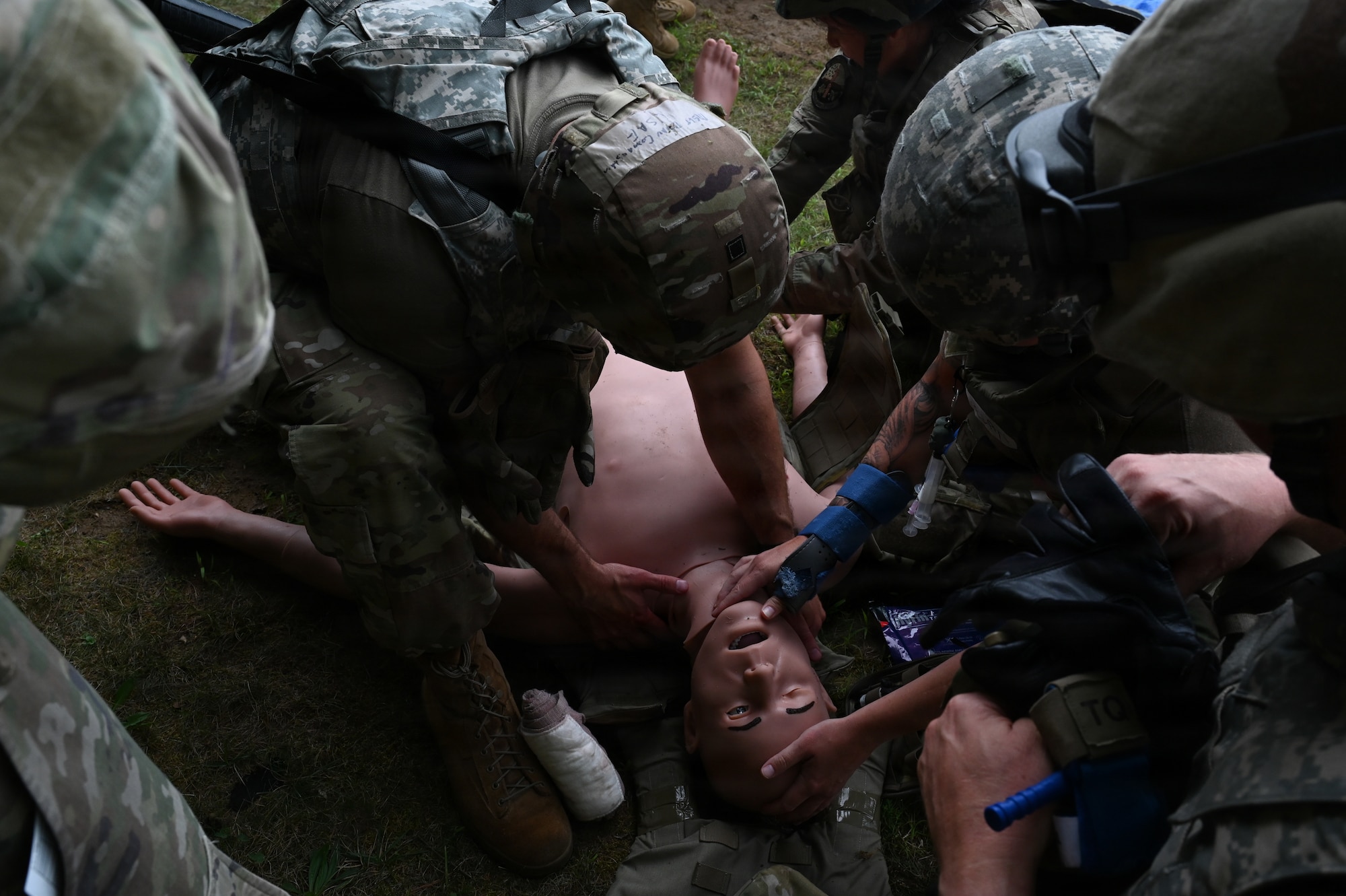 Tier 3 and Tier 2 Tactical Combat Casualty Care (TCCC) Airmen work together to evaluate a simulated casualty at Barnes Air National Guard Base, Westfield, Mass., August 20, 2026. Airmen used various skills learned, including head tilts, blood sweeps, and tourniquets. (U.S. Air National Guard photo by Airman 1st Class Ellen Ozkaptan)