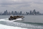 A U.S. Coast Guard Maritime Security Response Team (MSRT) West boat transits toward its return location following a simulated non-compliant boarding exercise as part of PANAMAX 2026, with Panama City in the background, Aug. 5, 2026.