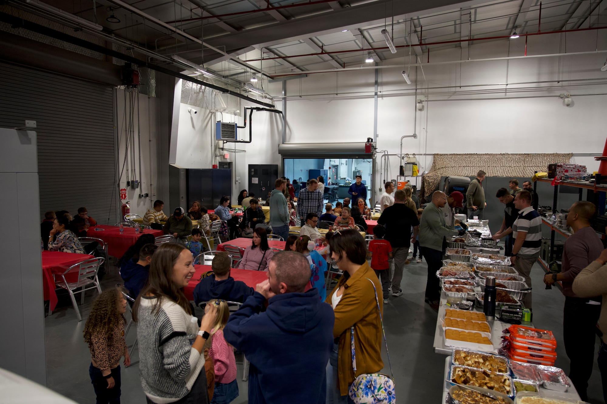 People gathered around tables of food at an event.