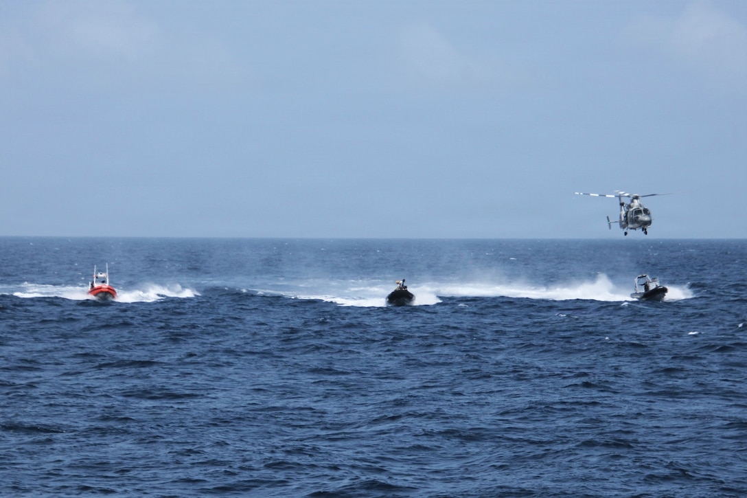 A Mexican Navy AS565 MBe Panther multi-mission helicopter from the ARM Jalisco hovers over a U.S. Coast Guard Over The Horizon MK 5 small boat, a Colombian Navy small boat, and an Ecuadorian Navy small boat during a pursuit training on the Pacific Ocean near Panama, Aug. 10, 2026.