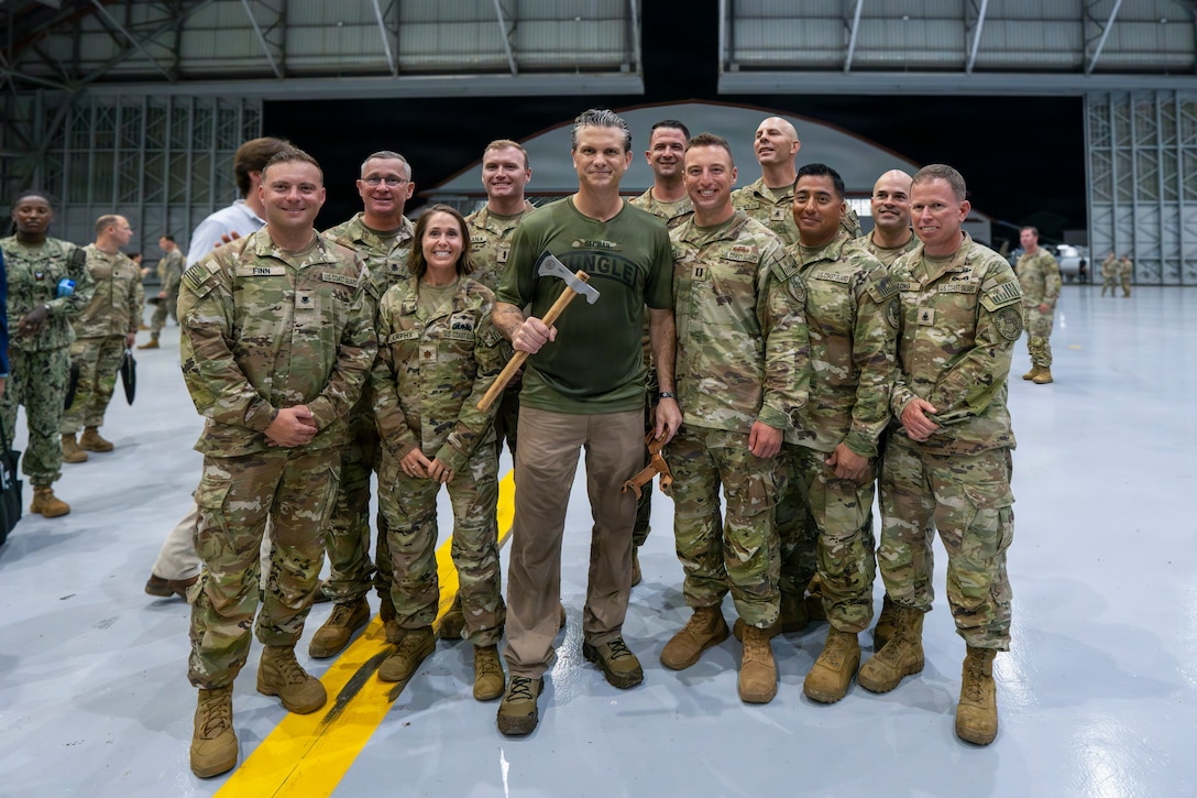 The Honorable Pete Hegseth, Secretary of War, stands with U.S. Coast Guard Port Security Unit 301 (PSU 301) service members and a commemorative gift presented by the unit during a dinner at Panama City, Panama, Aug. 12, 2026, in support of PANAMAX 2026.