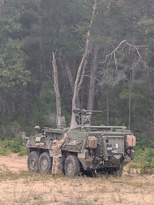 A Montana Army National Guard soldier assigned to the 631st Chemical Company inspects a Stryker vehicle during the Northern Strike 26-2 exercise at Camp Grayling, Michigan, in August 2026.