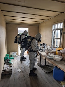 Soldiers from the Montana Army National Guard’s 631st Chemical Company analyze a simulated chemical agent inside a training facility during Northern Strike 26-2 at Camp Grayling, Michigan, in August 2026.