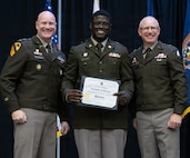 Newly commissioned 2nd Lt. Chris Williams is presented with certificate of completion of the Illinois Army National Guard Officer Candidate School.