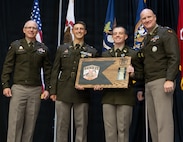 2nd Lt. Sean Wilhour, second from left, and 2nd Lt. Joseph Fisher, second from right, present a gift from Officer Candidate School Class 71-26 to Brig. Gen. Michael Eastridge, left, Deputy Assistant Adjutant General, Illinois Army National Guard, and Col. Paul Metzdorff, Commander, 129th Regiment.