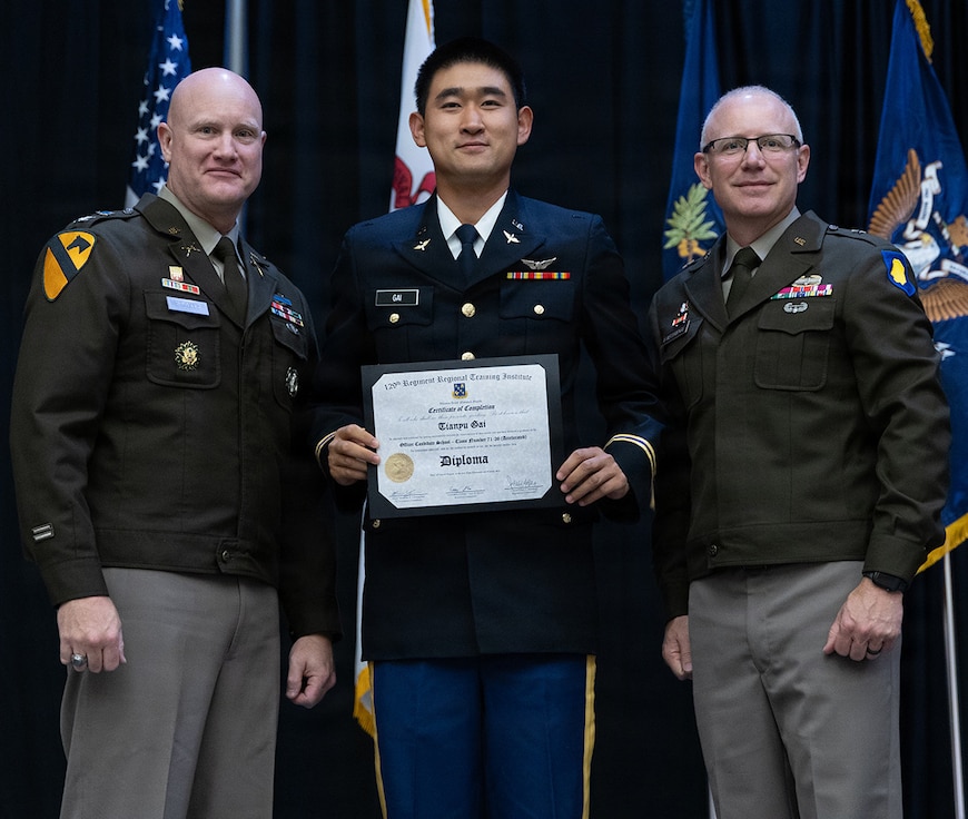 Newly commissioned 2nd Lt. Tianyu Gai is presented with certificate of completion of the Illinois Army National Guard Officer Candidate School.