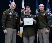 Newly commissioned 2nd Lt. Timothy Gillmore is presented with certificate of completion of the Illinois Army National Guard Officer Candidate School.