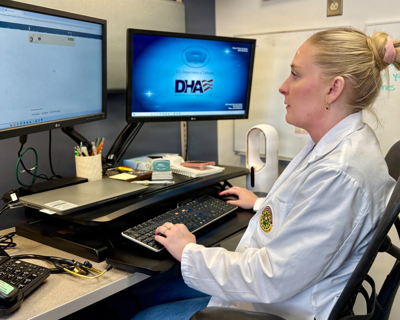 Defense Health Agency Physician Assistant Mikaela Altis logs into the Ambient Listening program to review a patient record at Munson Army Health Center, Fort Leavenworth, Kansas, Aug. 14, 2026. The program uses AI and speech recognition to quietly record and convert doctor-patient conversations into structured medical notes.The secure technology supports health care delivery by helping providers document visits more efficiently, allowing them to focus more attention on their patients.