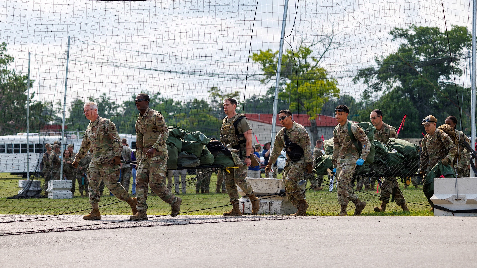 U.S. Air Force and Air National Guard medical personnel move patients to a hardened shelter during Exercise Northern Strike 26-2 at Alpena Combat Readiness Training Center, Michigan, Aug. 10, 2026.