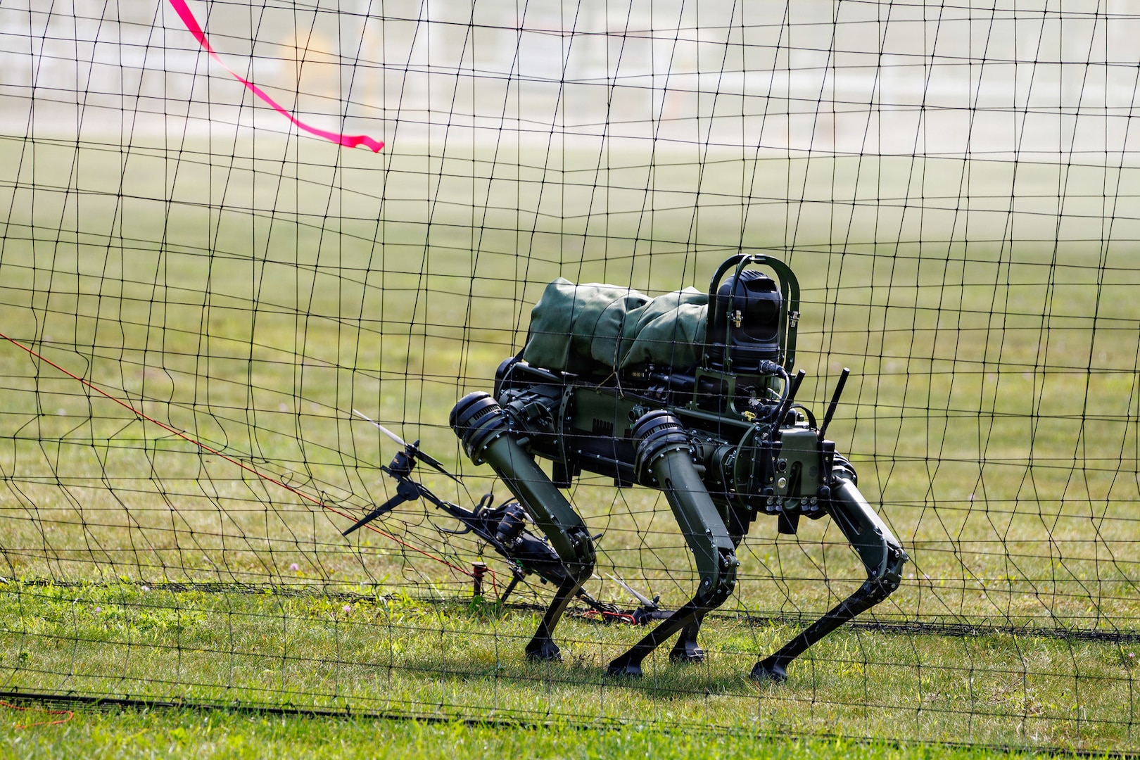 A quadruped unmanned ground vehicle is positioned near a downed drone during Exercise Northern Strike 26-2, at Alpena Combat Readiness Training Center, Michigan, Aug. 10, 2026.