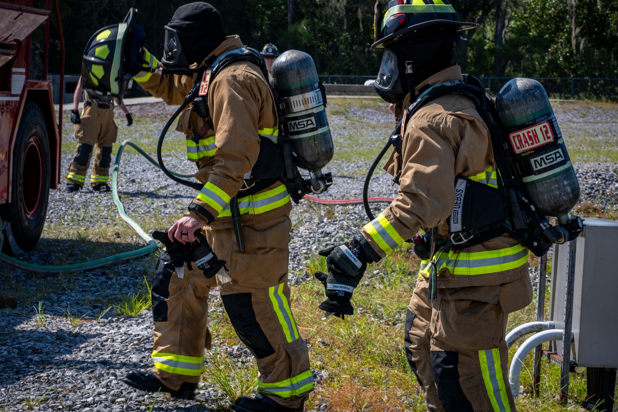 firefighters remove bunker gear following emergency response training