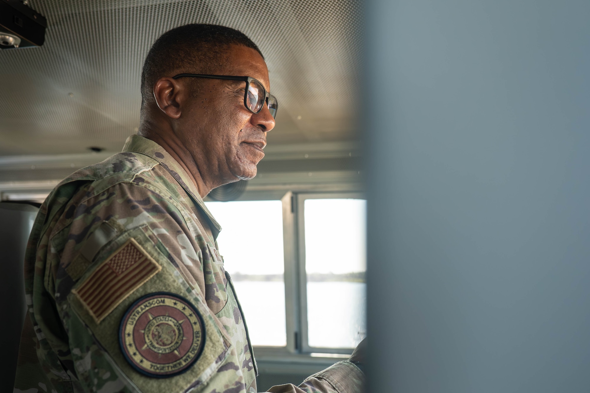 A photo of a service member inside of a locomotive.