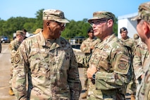 A photo of two service members conversing outside.