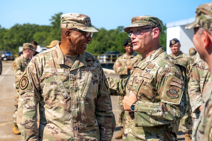 A photo of two service members conversing outside.