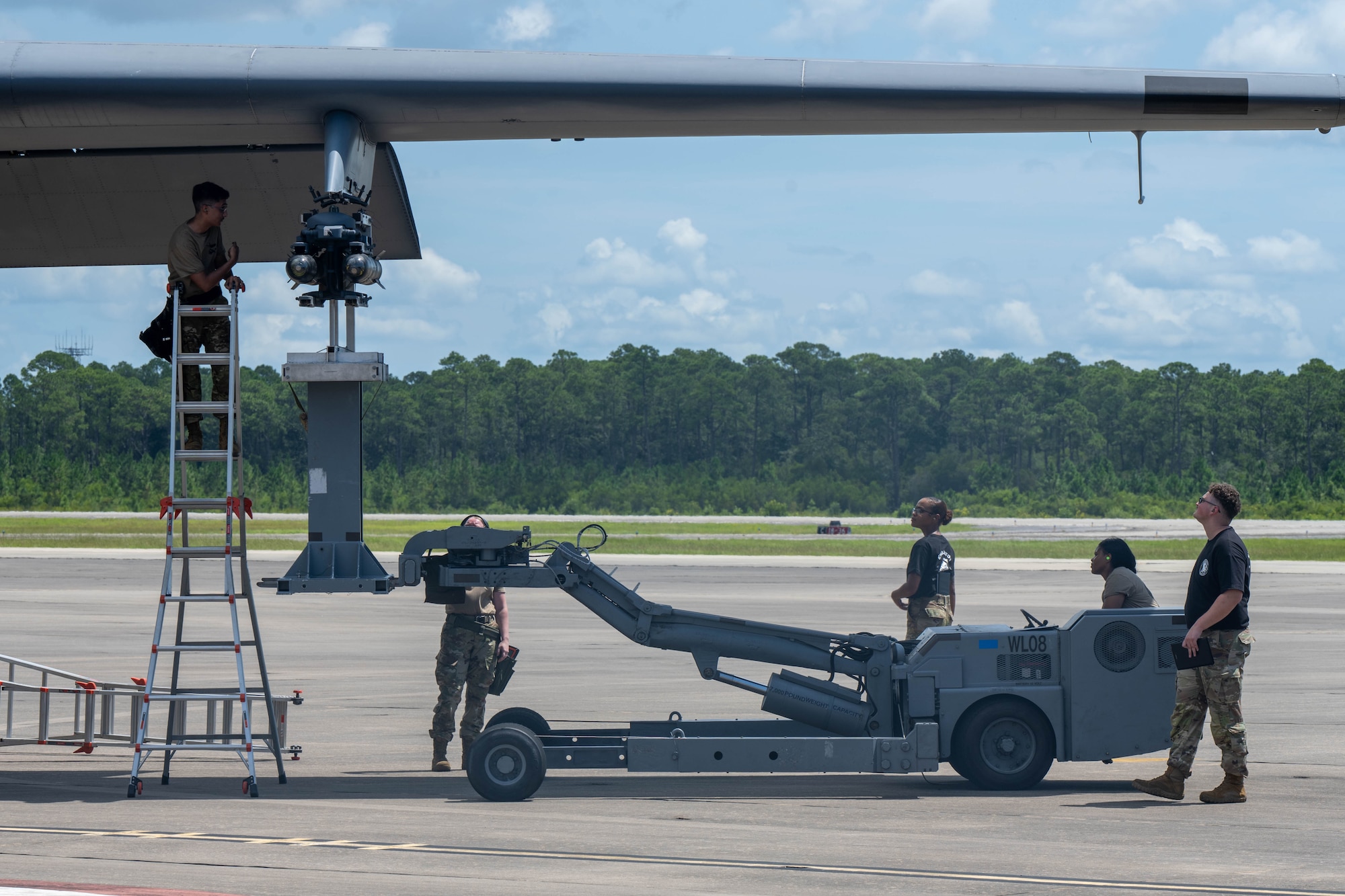 Airmen assigned to the 27th Special Operations Wing load a training missile onto an AC-130J Ghostrider