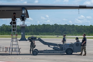 Airmen assigned to the 27th Special Operations Wing load a training missile onto an AC-130J Ghostrider