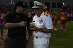 BILLINGS, Mont. (Aug. 22, 2026) – U.S. Navy Rear Adm. Matthew Case, acting Surgeon General and acting chief, U.S. Navy Bureau of Medicine and Surgery, receives a game ball at the Savannah Bananas baseball game during Billings Navy Week, Aug. 22. Navy Medicine's 44,000+ talented and ready forces optimize health readiness, deliver quality healthcare, and provide global expeditionary medical support to warfighters. (U.S. Navy photo by Violet Gruber)