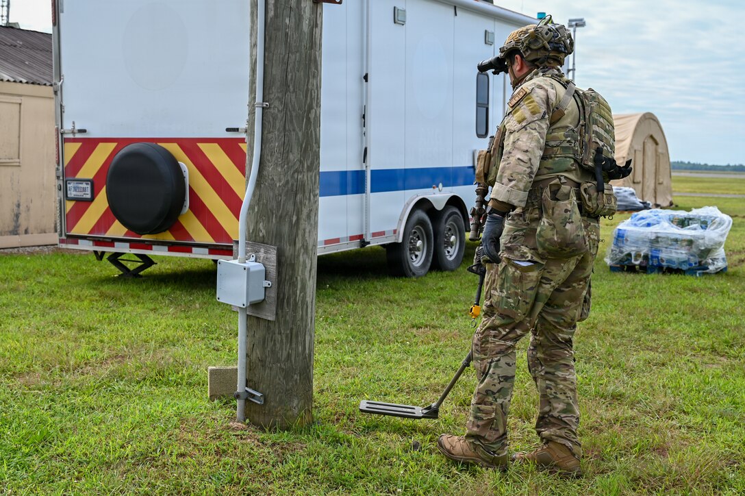 A U.S. Explosive Ordinance Disposal Airman from the 104th EOD Flight sweeps for explosives during a Combat Readiness Exercise at Westover Air Reserve Base, Chicopee, Mass., Aug. 23, 2026. Improvised explosive devices, or IEDs, continue to present great risk to servicemembers operating in previously enemy-occupied areas, especially in areas like the U.S. Central Command or U.S. African Command.(U.S. Air National Guard photo by Airman 1st Class Elijah Harris)