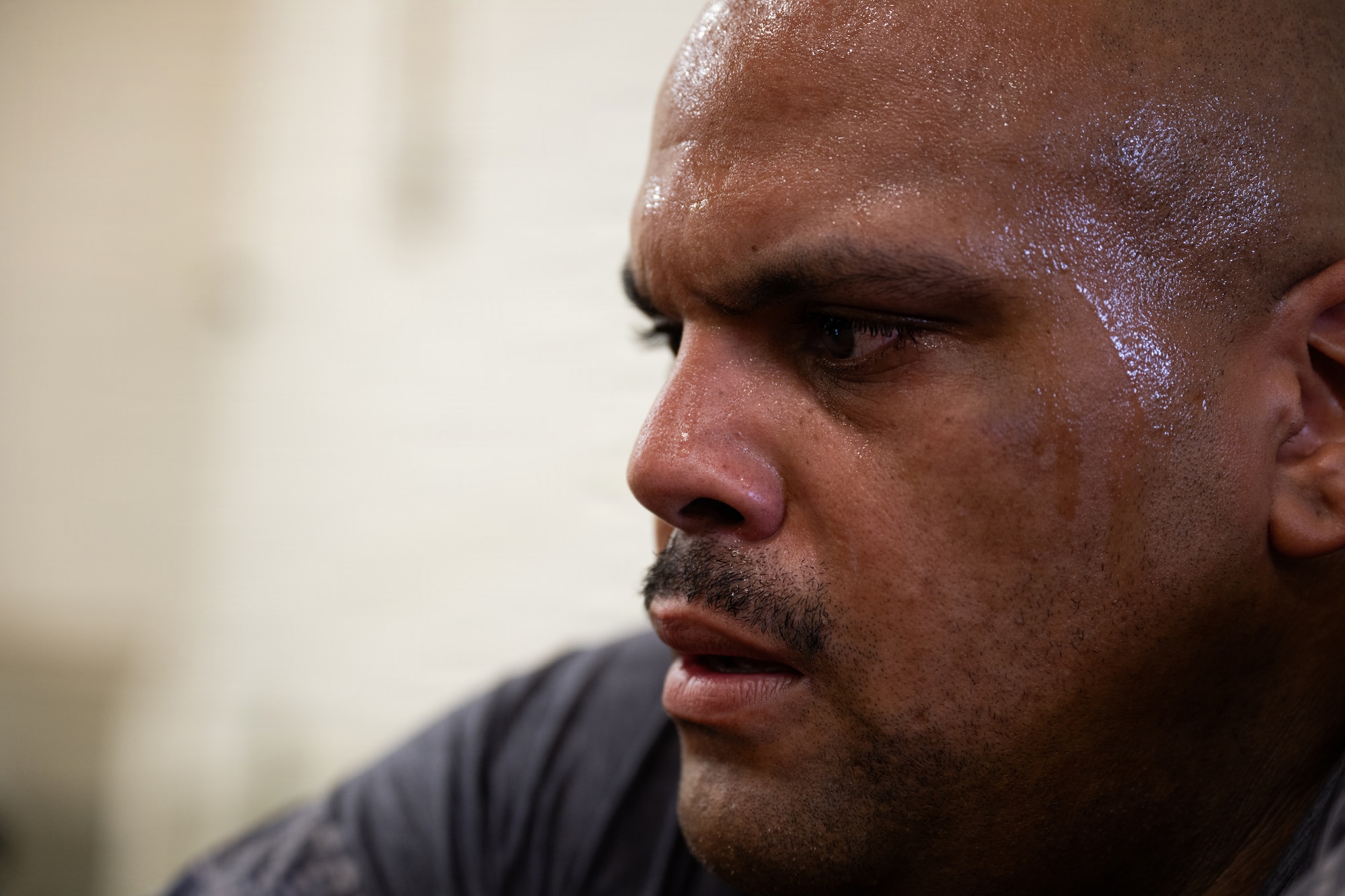 A servicemember looks at their phone during a physical challenge.