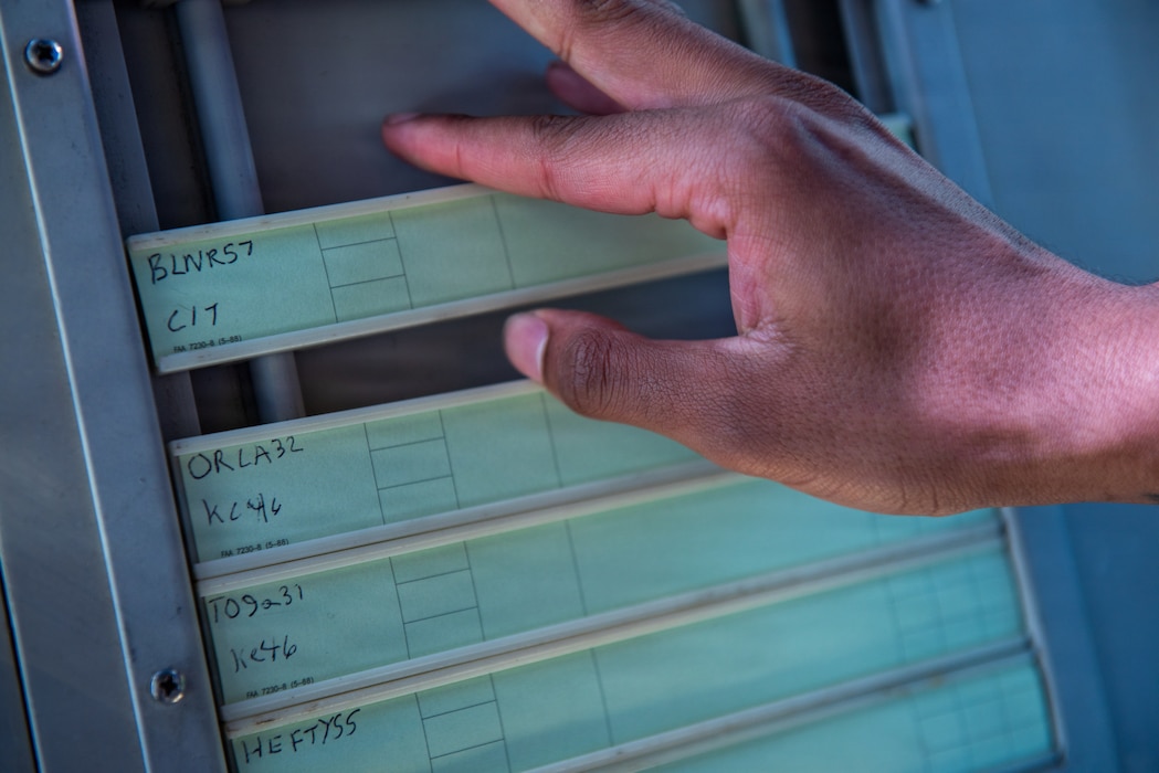 Airman organizing flight progress strips