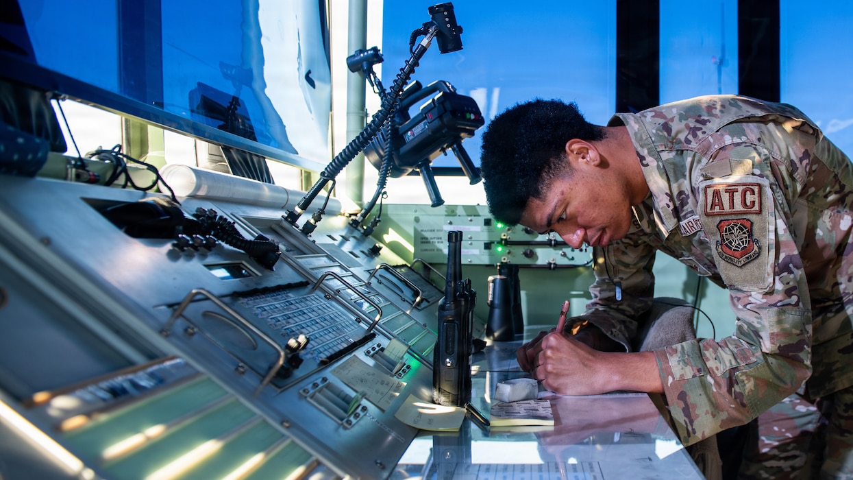 Airman writing on a flight progress strip