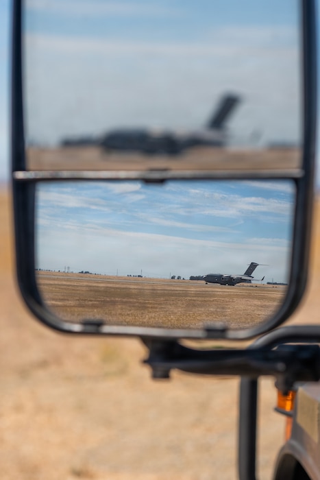 Aircraft reflected in a side-view mirror