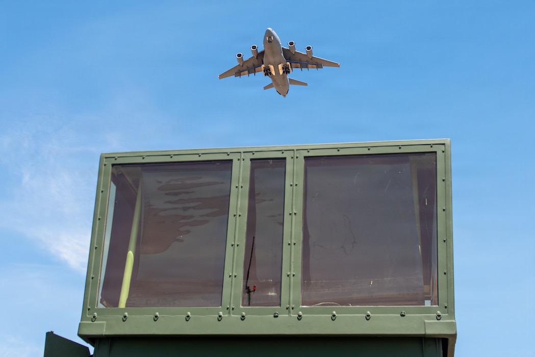 Aircraft flying over mobile control tower