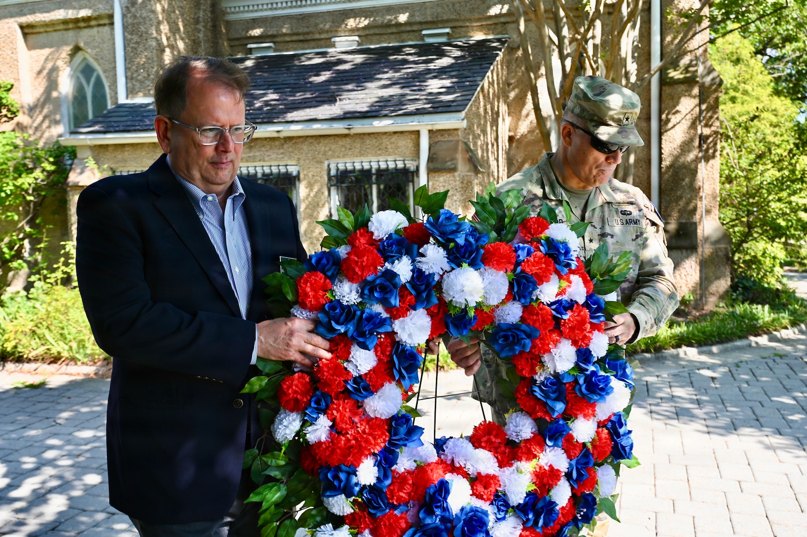 Mark Hudson, Executive Director of Historic Congressional Cemetery, and U.S. Army Brig. Gen. Leland D. Blanchard II, Commanding General (Interim) of the D.C. National Guard, lay a wreath at the grave of U.S. Army Pvt. Andrew Coyle during a Battle of Bladensburg commemoration at Historic Congressional Cemetery in Washington, D.C., Aug. 24, 2026. The Maryland Society, Sons of the American Revolution Color Guard then rendered a ceremonial volley honoring the Citizen-Soldiers who answered the call to defend the nation’s capital in 1814.