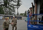 Senior Master Sgt. Ryan Silsbee (left), the senior enlisted leader of the 149th Civil Engineering Squadron (CES), 149th Fighter Wing, Texas Air National Guard, discusses construction operations with 149th CES members during an Air National Guard (ANG) deployment for training (DFT) project on Camp Murray, in Lakewood, Washington, June 30, 2026. The 149th CES is conducting their annual training as part of the DFT to renovate a warehouse into a new fitness center for the 194th Wing, Washington ANG. (U.S. Air National Guard Photo by Maj. Phil Fountain)