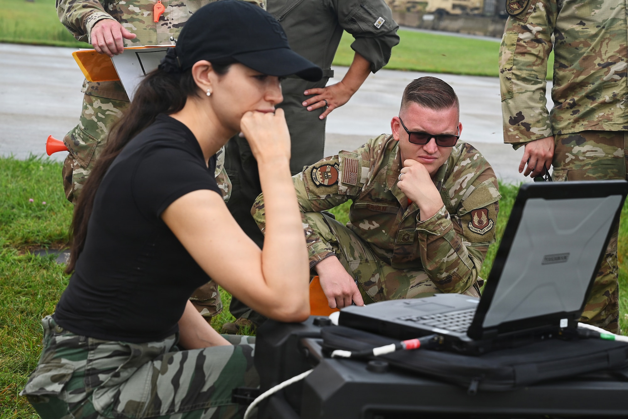Members of the Air Force and Ohio Air National Guard look at laptops during field prototype testing evaluation for the Collaborative Combat Aircraft (CCA) Portable Command and Control Enclave (C2E).

(U.S. Air National Guard photo by Shane Hughes).