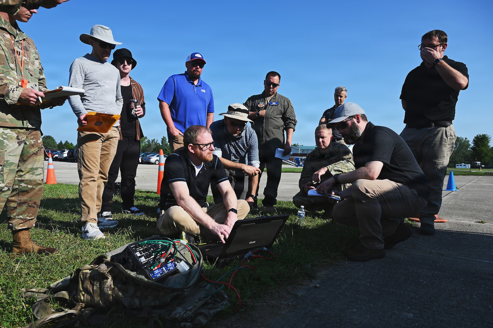 Members of the Air Force and Ohio Air National Guard look at laptops during field prototype testing evaluation for the Collaborative Combat Aircraft (CCA) Portable Command and Control Enclave (C2E).

(U.S. Air National Guard photo by Shane Hughes).
