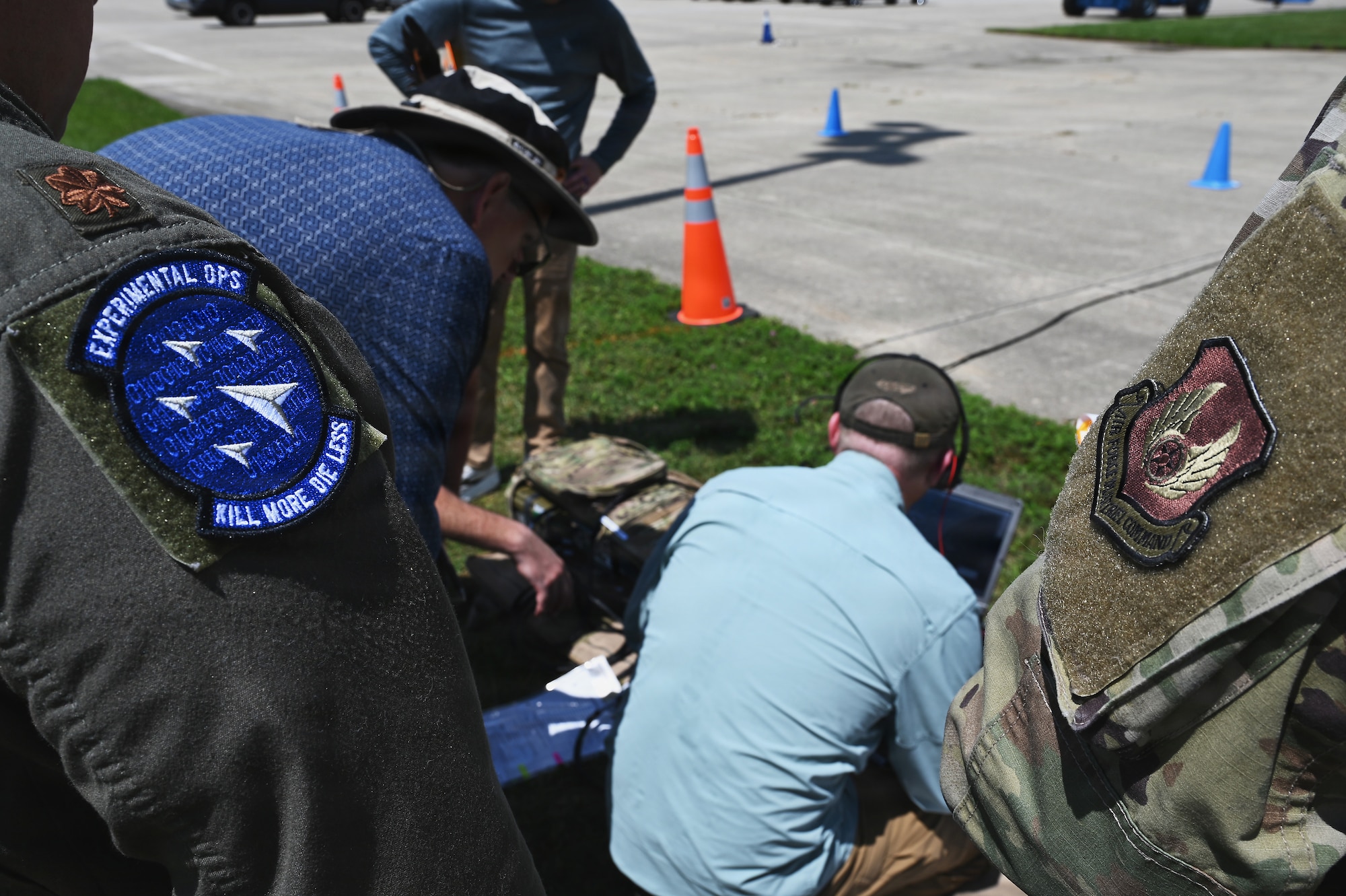 Members of the Air Force and Ohio Air National Guard look at laptops during field prototype testing evaluation for the Collaborative Combat Aircraft (CCA) Portable Command and Control Enclave (C2E).

(U.S. Air National Guard photo by Shane Hughes).