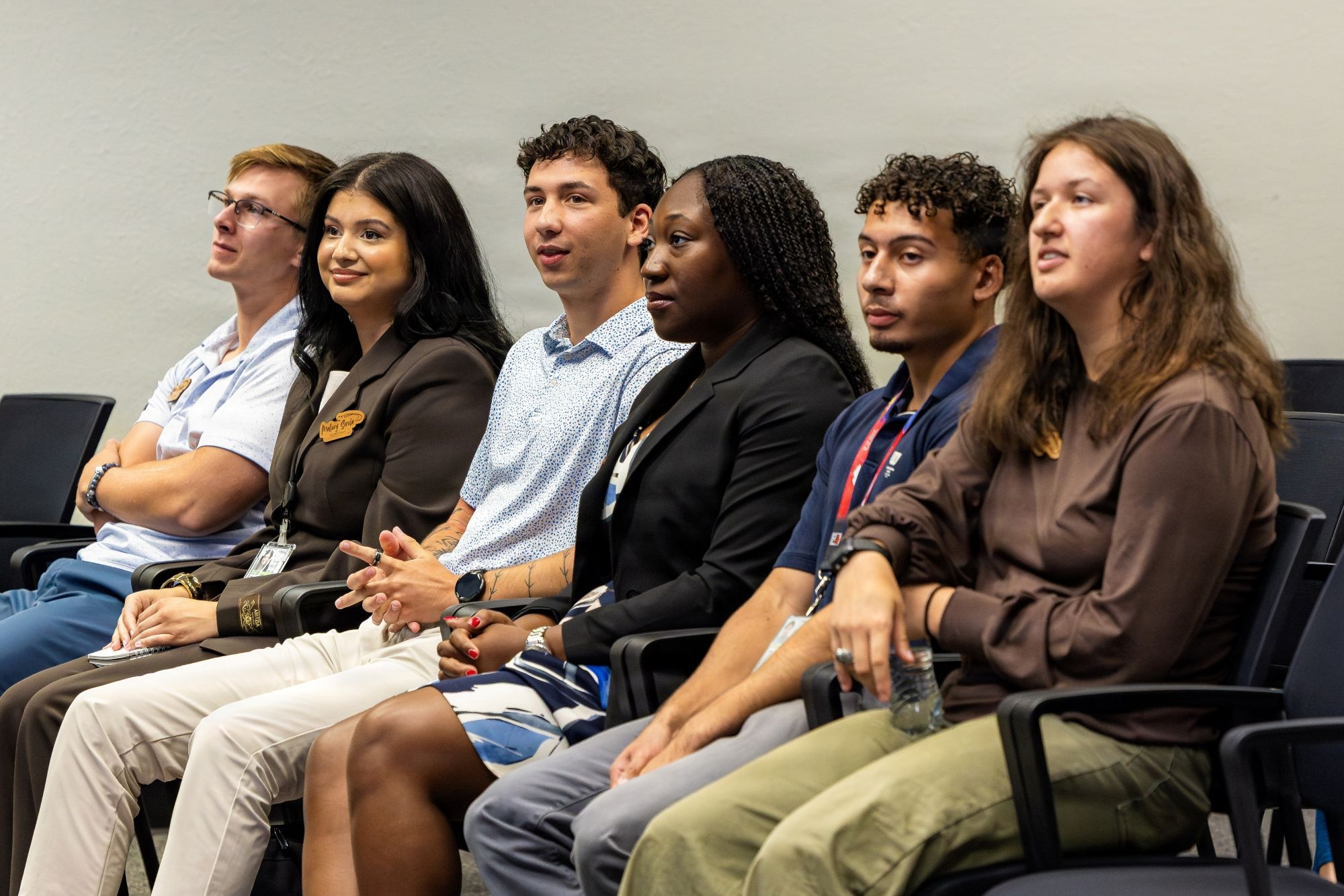 Ryan Soroka, Mallory Sorola, Connor English, Ciara Laird, Rodrick Benson and Ana Lemler, Virtual Institutes for Cyber and Electromagnetic Spectrum Research and Officer Training interns, watches Alejandro Cardona (not pictured) deliver his culmination presentation following a 10-week program at Edwards Air Force Base, California, Aug. 7, 2026. The Department of War VICEROY initiative cultivates cyber-spectrum leadership by funding student travel to military research centers, removing geographic barriers to defense careers. During the inaugural cohort at Edwards, seven interns supported active aerospace and cyber test programs. (U.S. Air Force photo by Ariana Ortega)