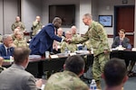 Gen. Gregory Guillot, commander of North American Aerospace Defense Command (NORAD) and U.S. Northern Command (USNORTHCOM), greets the honorable Earl Matthews, General Counsel of the Department of War, at Peterson Space Force Base, Colorado, during the NORAD and USNORTHCOM Legal Symposium Aug. 20, 2026. The three-day event provided an opportunity for collaboration on critical topics, including Arctic Operations, authorities to counter threats from unmanned aerial systems, and legal interoperability. (Department of War photo by Blake Macias)