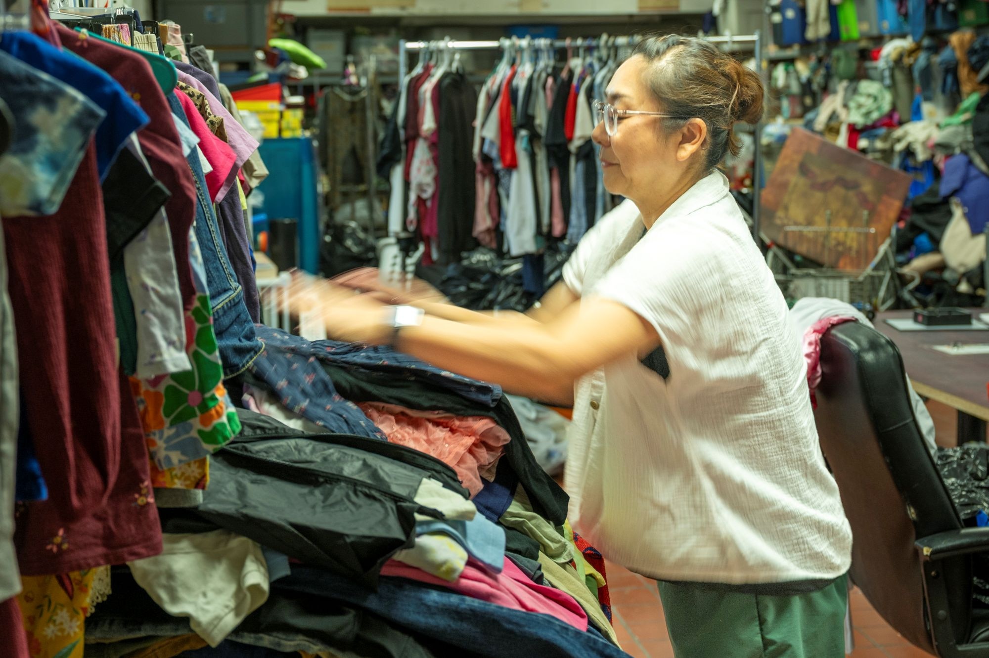 Sanae Triplett, volunteer and spouse of a retired Air Force veteran, organizes donated clothing by age and gender at the Airman’s Attic, Edwards Air Force Base, California, on Aug. 19. Triplett volunteers at the facility three times a week after dropping her daughter off at Branch Elementary School on base. (U.S. Air Force photo by Laisa Leao)