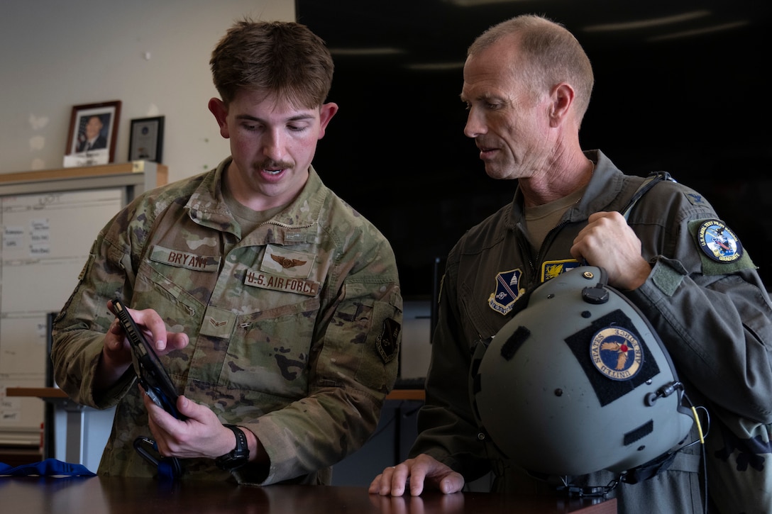 Photo of Airmen looking at flight map