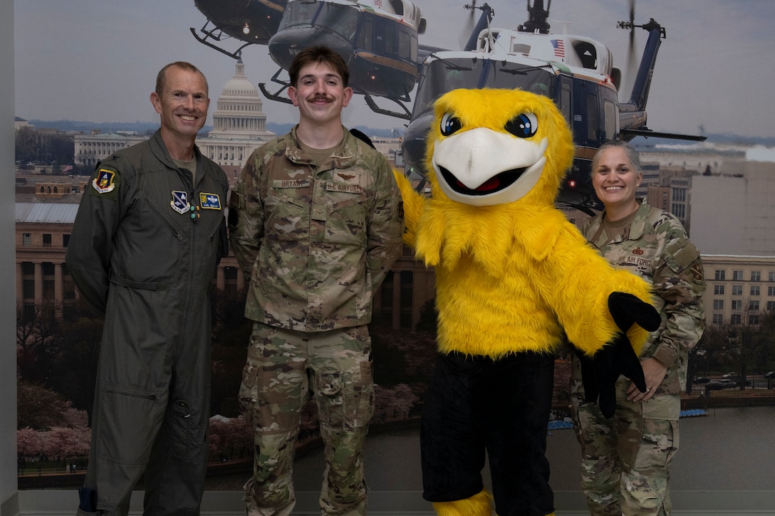 Photo of Airmen and Griffin mascot