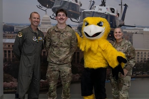 Photo of Airmen and Griffin mascot