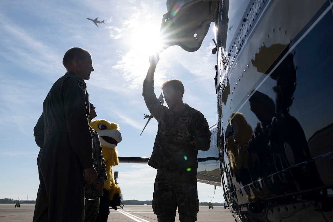 Photo of Airmen and UH-1N Huey