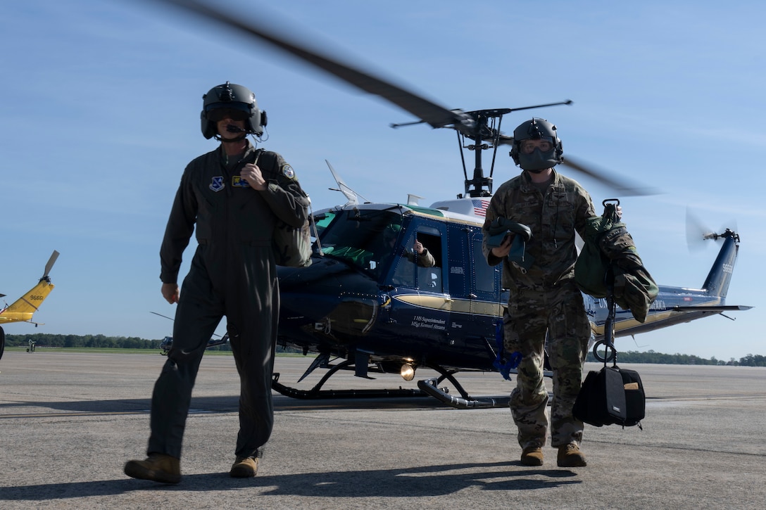 Photo of Airmen and helicopter