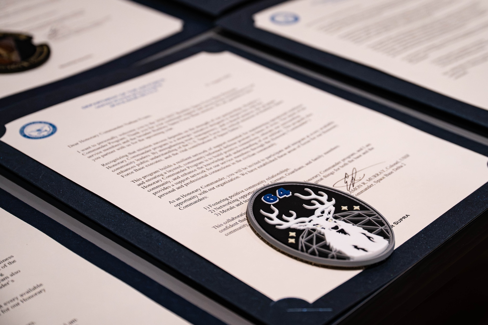 a close up of a certificate and a unit patch