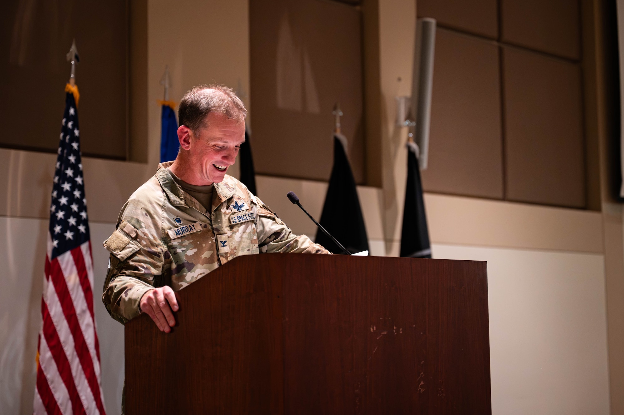 Uniformed service member stands at a podium
