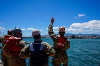 U.S. Navy Sailors serving as docking officers at Pearl Harbor Naval Shipyard and Intermediate Maintenance Facility (PHNSY & IMF) communicate with the crew of the Virginia-class fast-attack submarine USS North Carolina (SSN 777) via radio during an undocking evolution in Pearl Harbor, Hawaii, Aug. 12, 2026.