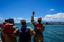 U.S. Navy Sailors serving as docking officers at Pearl Harbor Naval Shipyard and Intermediate Maintenance Facility (PHNSY & IMF) communicate with the crew of the Virginia-class fast-attack submarine USS North Carolina (SSN 777) via radio during an undocking evolution in Pearl Harbor, Hawaii, Aug. 12, 2026.
