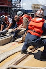 U.S. Navy Sailors assigned to the Virginia-class fast-attack submarine USS North Carolina (SSN 777) handle mooring lines as they prepare to moor the vessel along the piers in Pearl Harbor, Hawaii, Aug. 12, 2026.