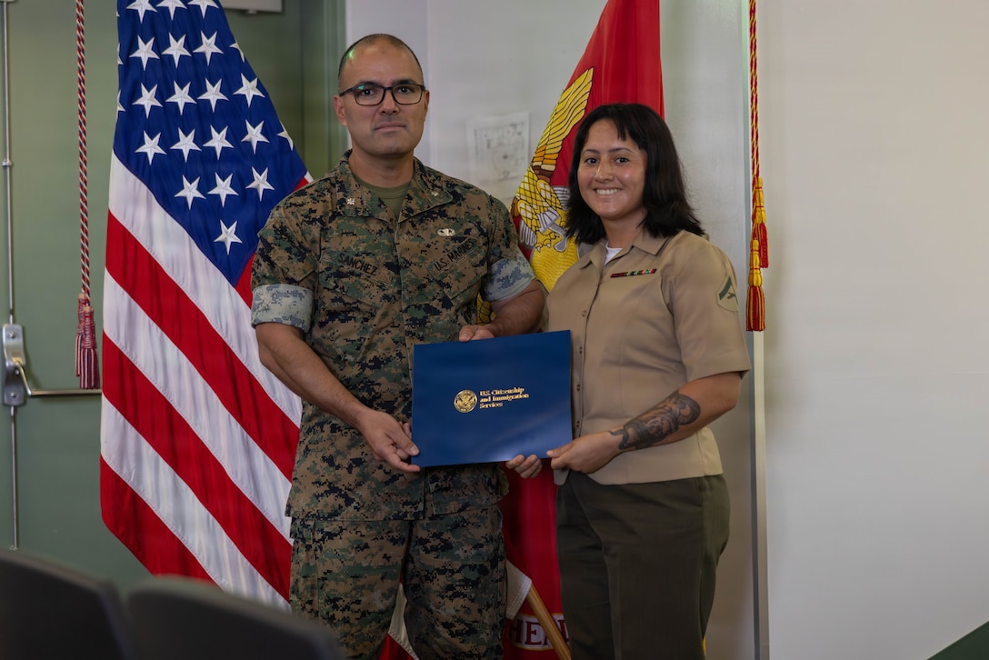 U.S. Marine Corps Lt. Col. Gabriel Sanchez, left, the commanding officer of Marine Wing Support Squadron (MWSS) 171, Marine Aircraft Group 12, 1st Marine Aircraft Wing, and a native of El Centro, California, and Lance Cpl. Yvi Fuentes, a motor vehicle operator with Marine Wing Support Squadron (MWSS) 171, MAG-12, 1st MAW, and a native of Guatemala, pose for a photo during a naturalization ceremony at Marine Corps Air Station Iwakuni, Japan, August 21, 2026. The naturalization ceremony was held to acknowledge military service members’ accomplishment of becoming a citizen of the United States. The ceremony included service members from Republic of Congo and Guatemala. (U.S. Marine Corps photo by Lance Cpl. Isaac De Leon)