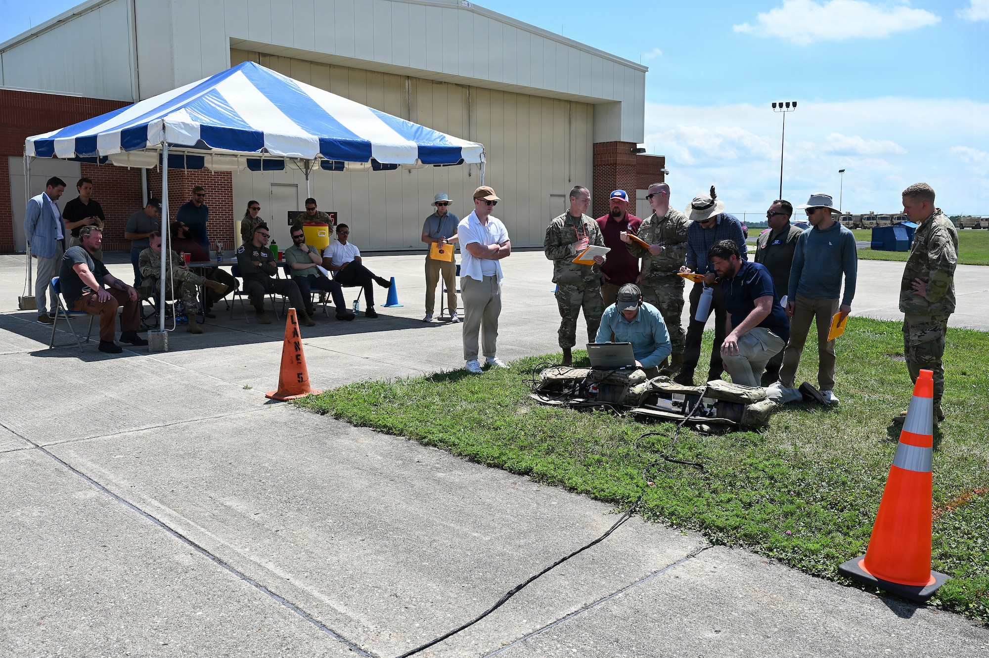 Members of the Air Force and Ohio Air National Guard look at laptops during field prototype testing evaluation for the Collaborative Combat Aircraft (CCA) Portable Command and Control Enclave (C2E).

(U.S. Air National Guard photo by Shane Hughes).